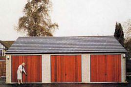 Real tiled roof and brick effect front posts on a block of Heritage garages.