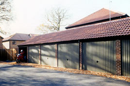 Real tiled roof and brick effect front posts on a block of Heritage garages.