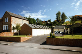 A stepped block of Heritage garages compliments these new-build houses